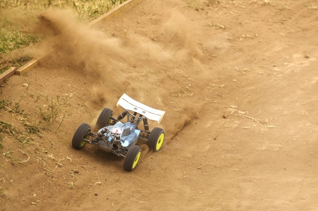 Radio controlled car model in race on dirt track